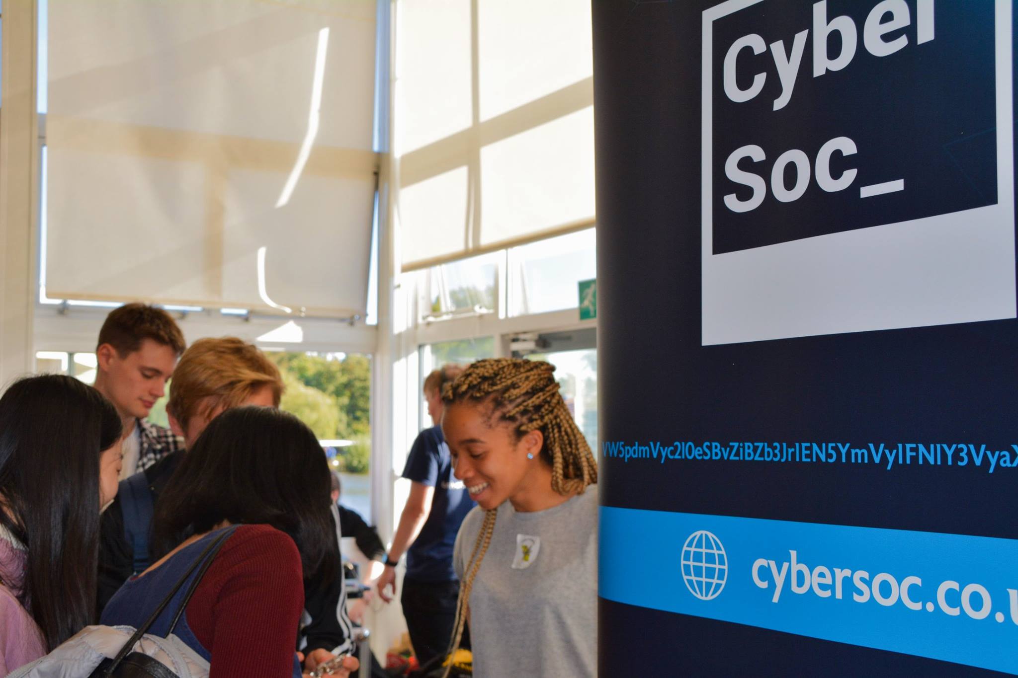 CyberSoc members and the society banner